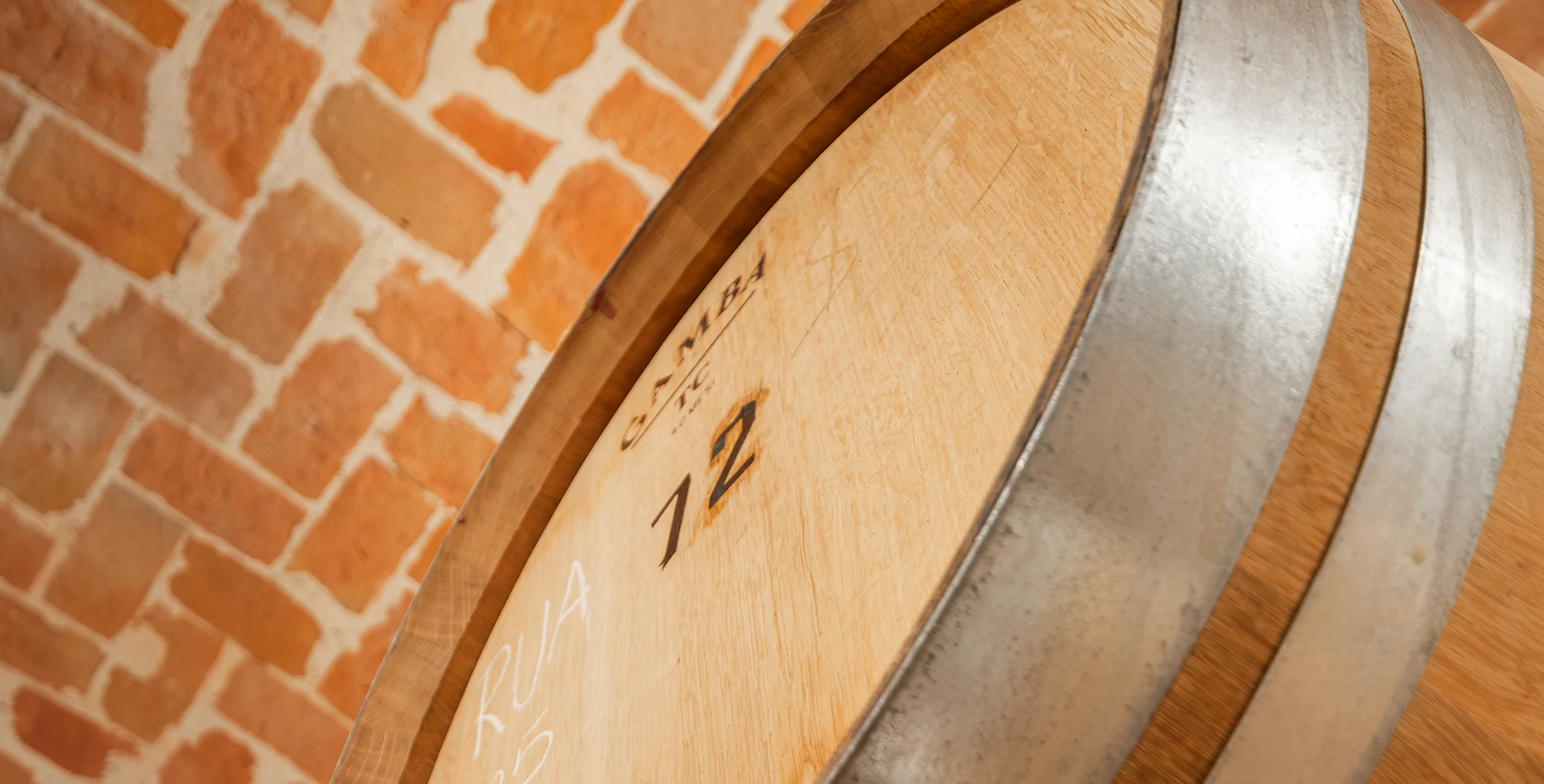 A detail of the barrels in the barrel room (barricaia) at Cascina La Barbatella